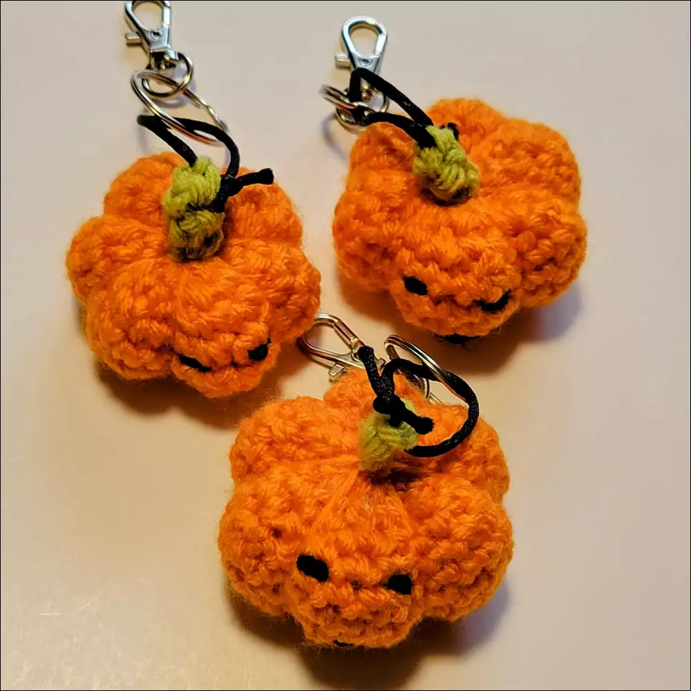Crocheted pumpkin keychains with smiling faces perfect for your coffee cup and more