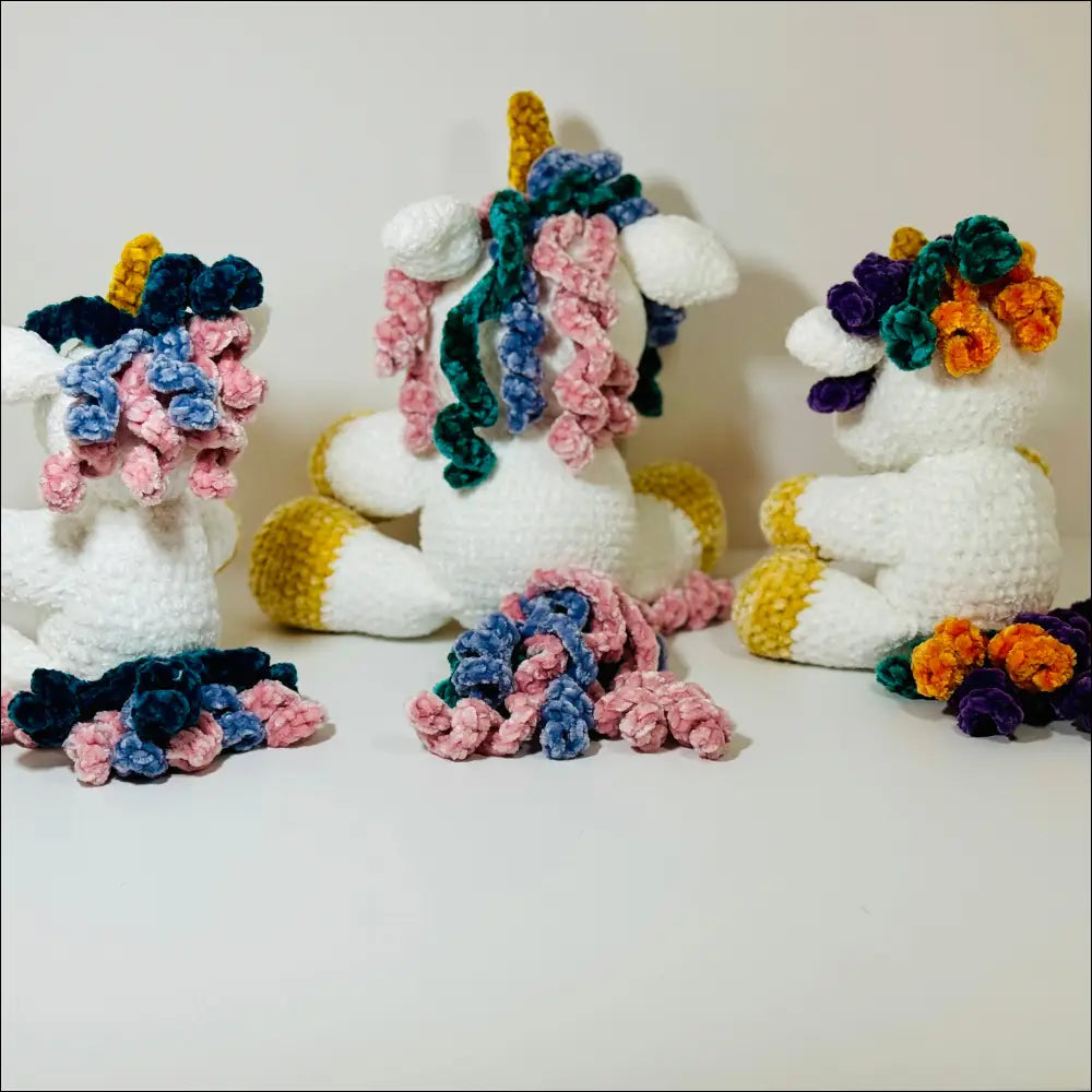 Cuddly unicorn plush with a colorful mane and flowers, perfect for all ages at checkout