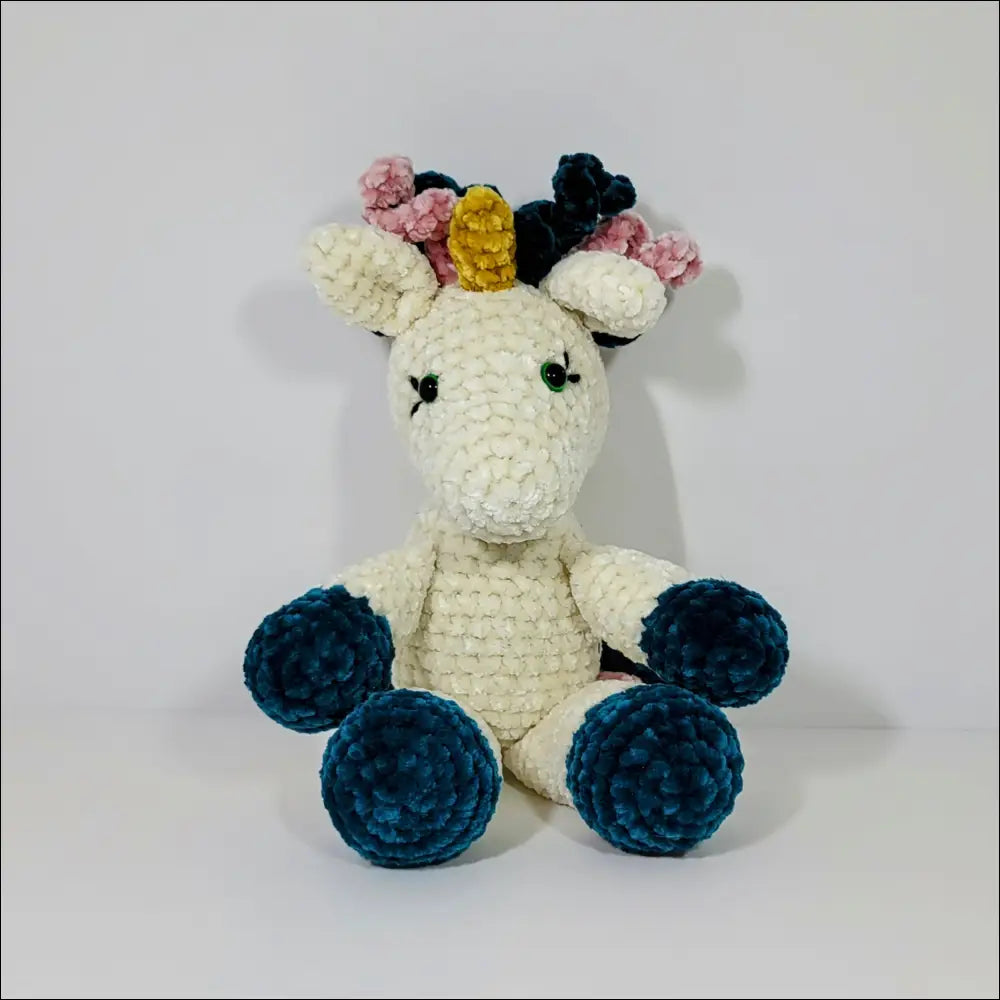 Crocheted unicorn plush toy with colorful mane, perfect for cuddling and fun at checkout
