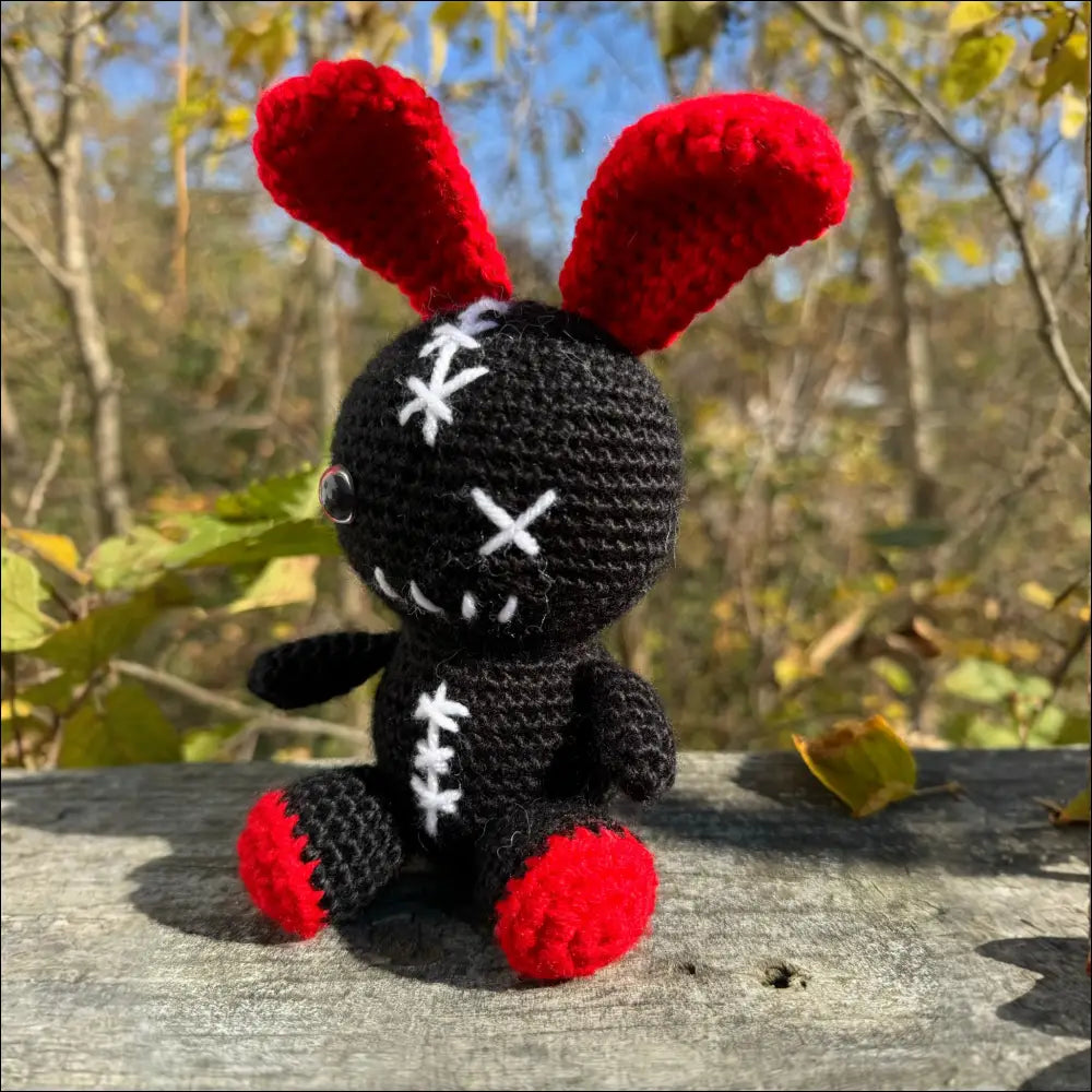 Crocheted black Zombie Bunny toy with red ears and feet for fun adventures