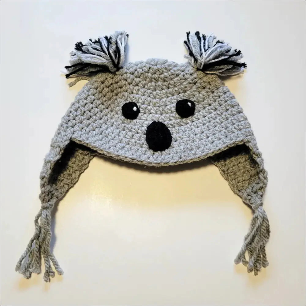 Crocheted gray koala hat with ear flaps and tassels for animal hat lovers