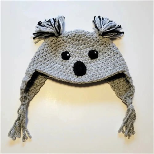 Crocheted gray koala hat with ear flaps and tassels for animal hat lovers