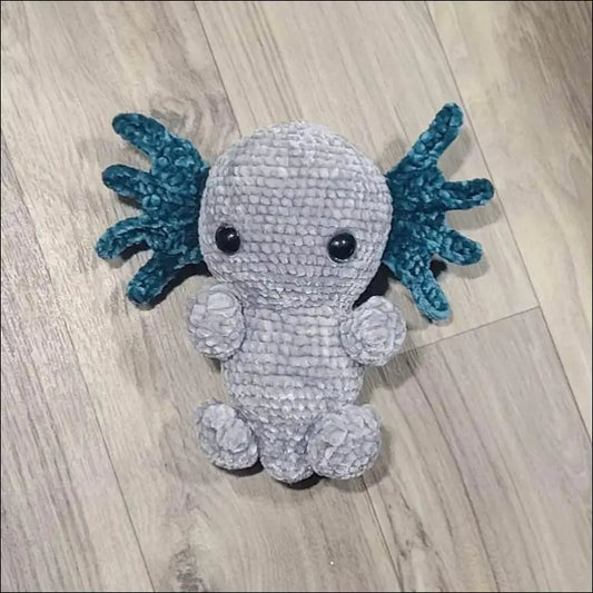 Crocheted axolotl plush toy with teal gills and gray body, perfect for Axolotl pattern crafting