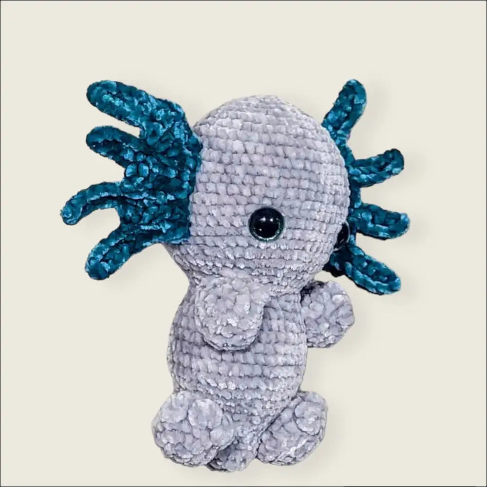 Crocheted gray axolotl toy with blue gills, perfect for cuddly fun