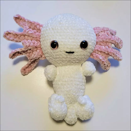 Cute crocheted axolotl toy with pink tentacles and big eyes, perfect for cuddly fun