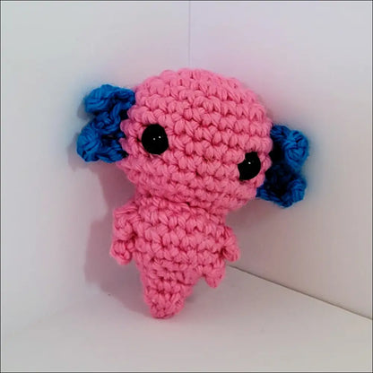 Cute pink and blue crochet Axolotl toy with a black eye for cuddly fun