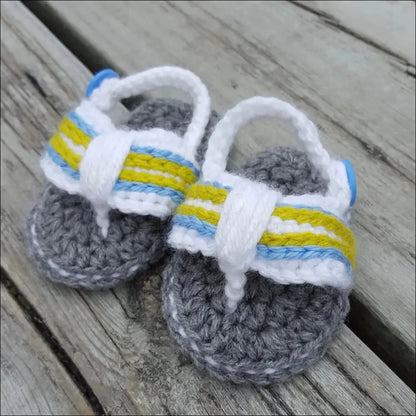 Pair of cute crocheted baby flip flops with fun white, yellow, and blue stripes