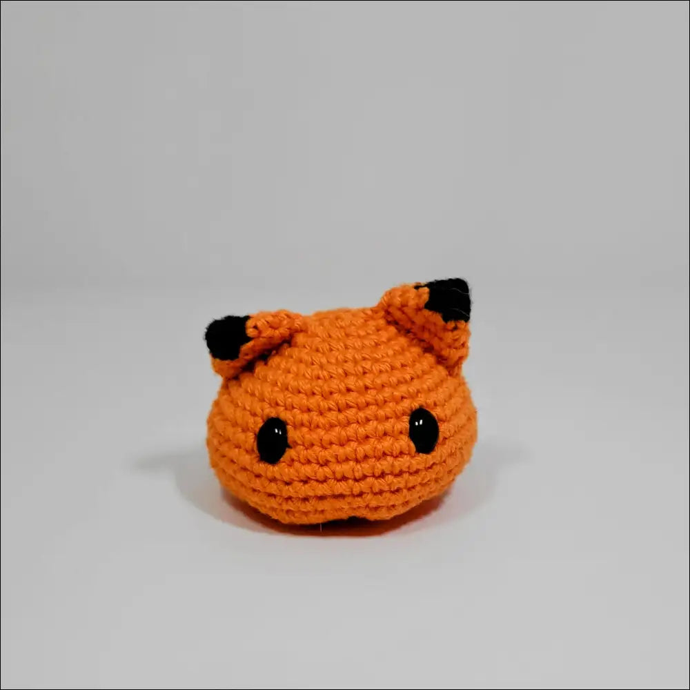 Cute orange Crochet Blobimals with black ears, perfect for playtime fun as a giraffe