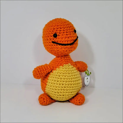 Crocheted orange and yellow Charmander toy with a cute smiling face for fans