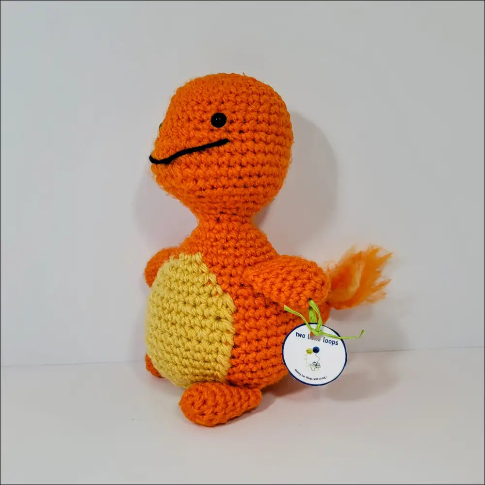 Crocheted orange and yellow Charmander toy perfect for Pokémon fans and collectors