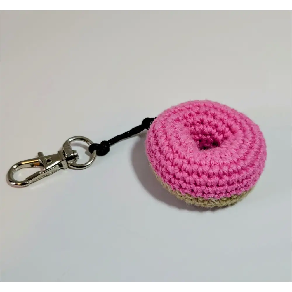 Pink crochet keychain with black handle perfect for your coffee cup and more