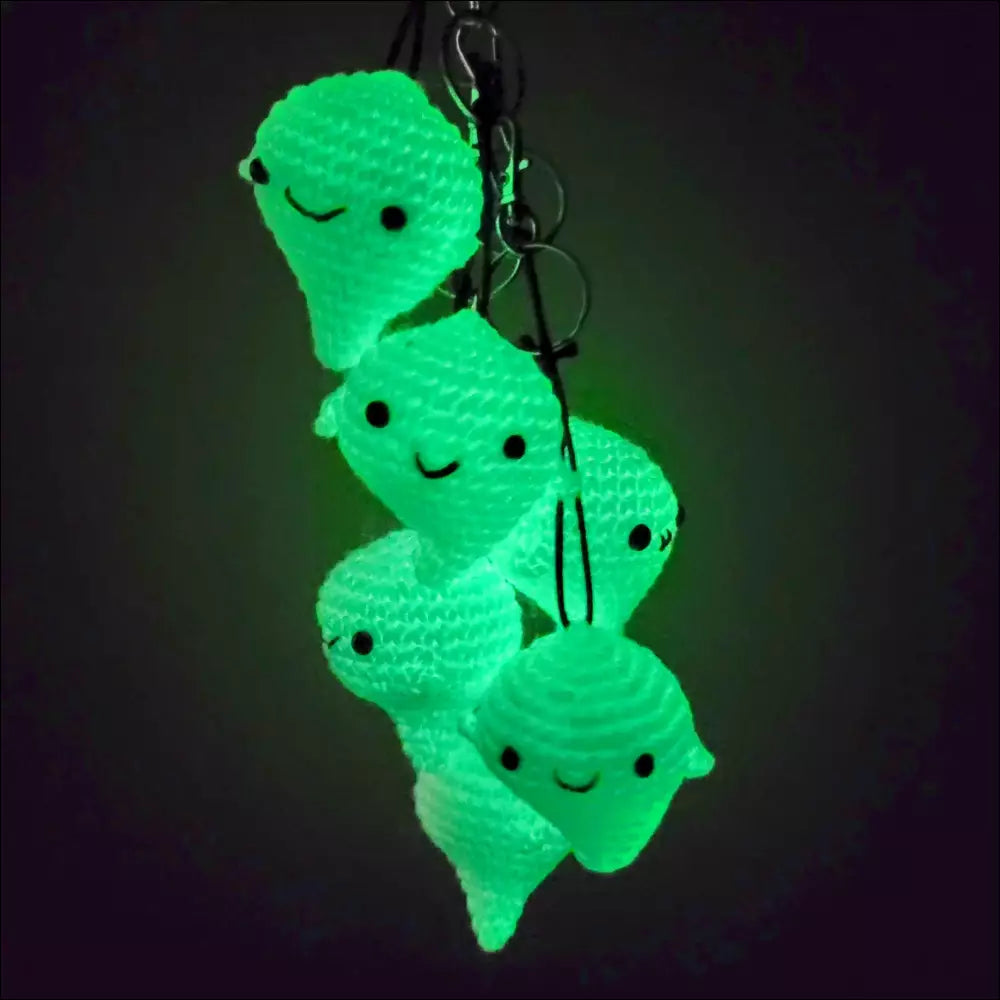 Glowing green ghost-shaped keychains stacked for your coffee cup and more fun!