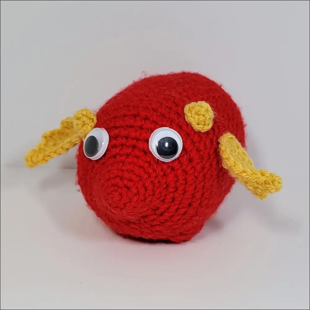 Red ball with yellow eye and nose on Cute and Goofy Derpy Dragon Plush Toy