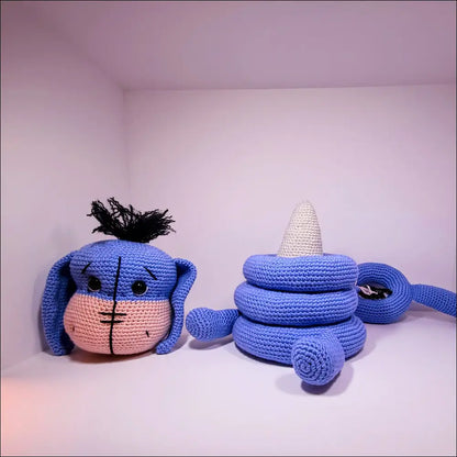 Two cute Croches chilling together with the Eeyore Stacker Toy for playtime fun