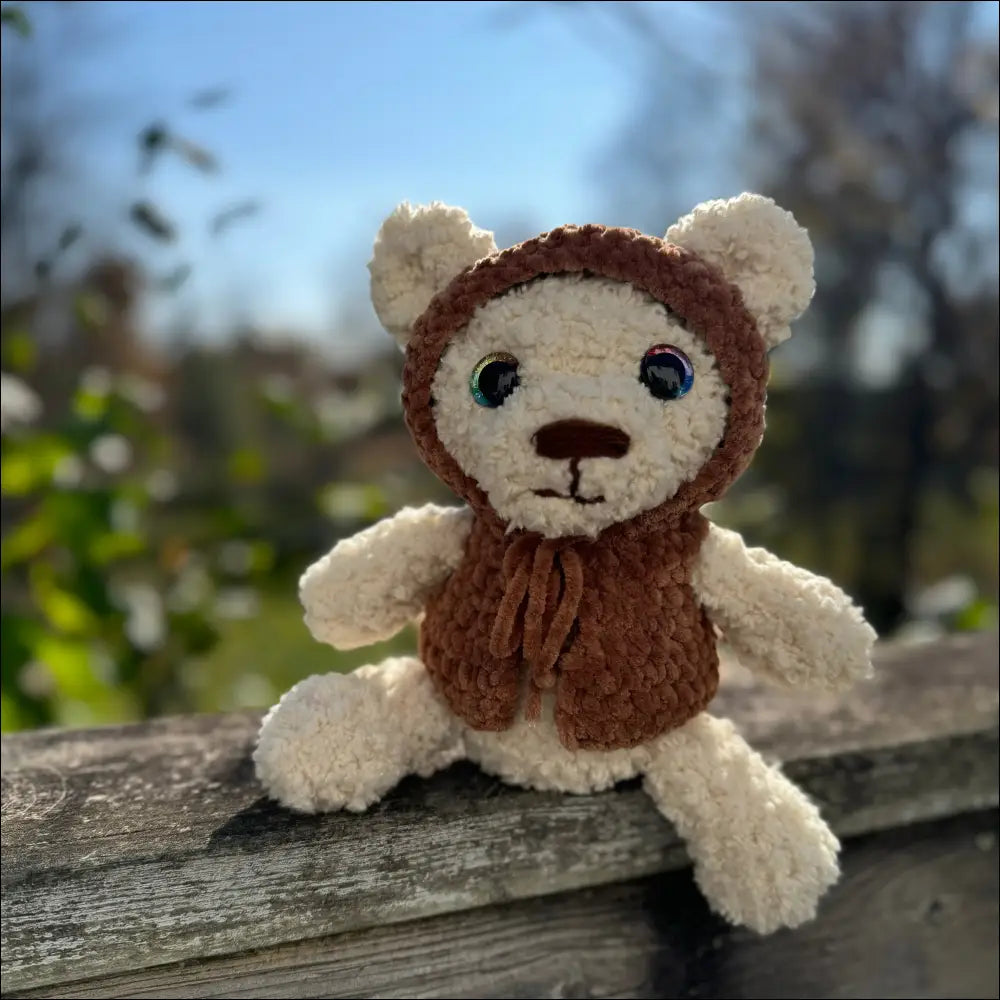 Plush fluffy bear in a cozy brown knitted hood for warm snuggles