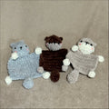 Three knitted or crocheted animal toys on a beige background