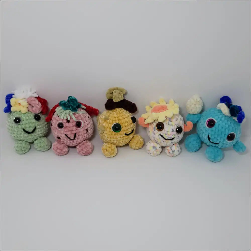 Colorful row of Adorable Hand-crocheted Forest Sprites with water drop design