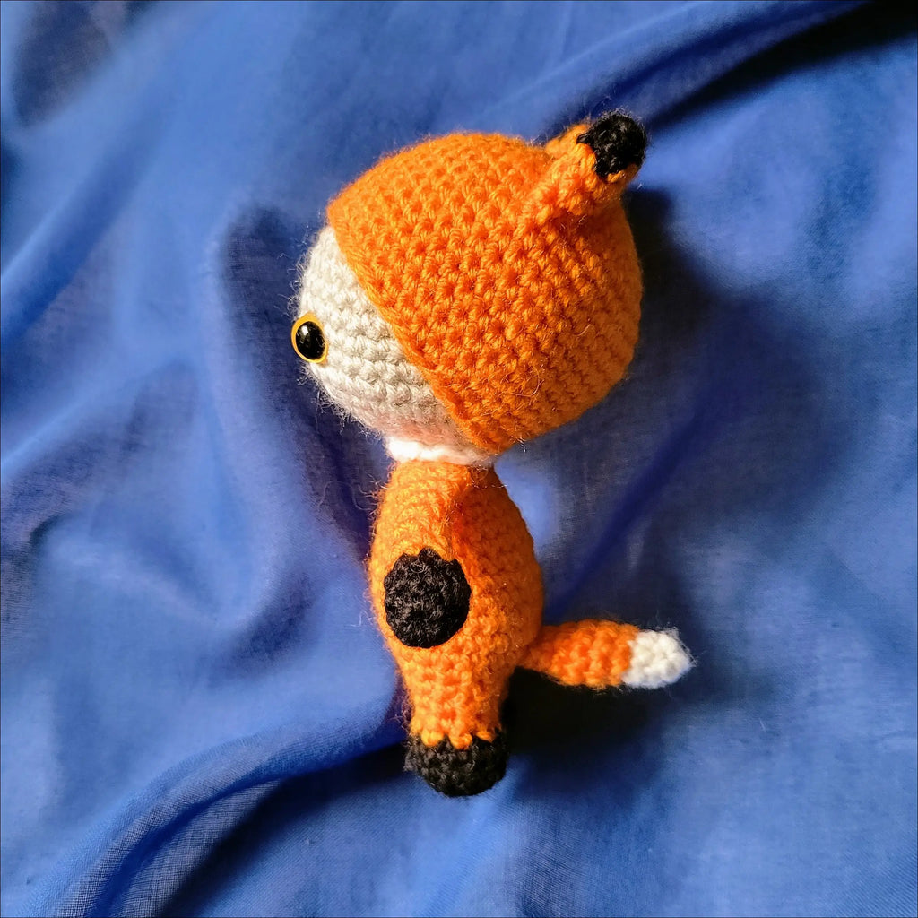 Adorable Crocheted orange fox pal, perfect for adventures and playtime fun!