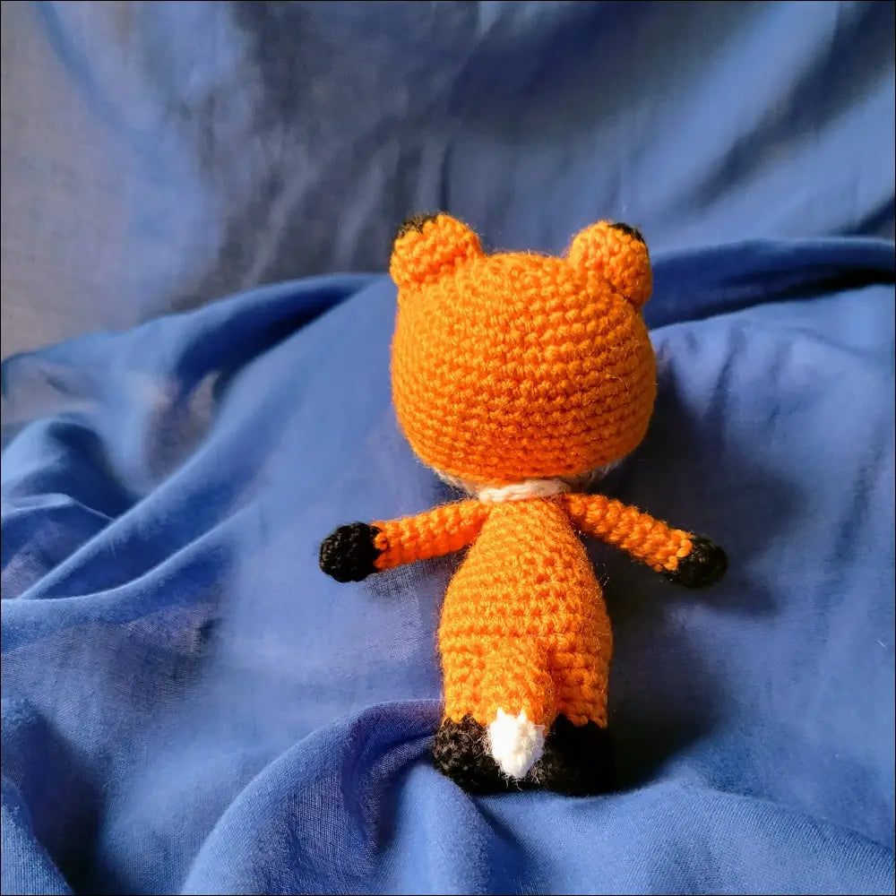 Crocheted orange fox pal toy with round ears and a cute white-tipped tail