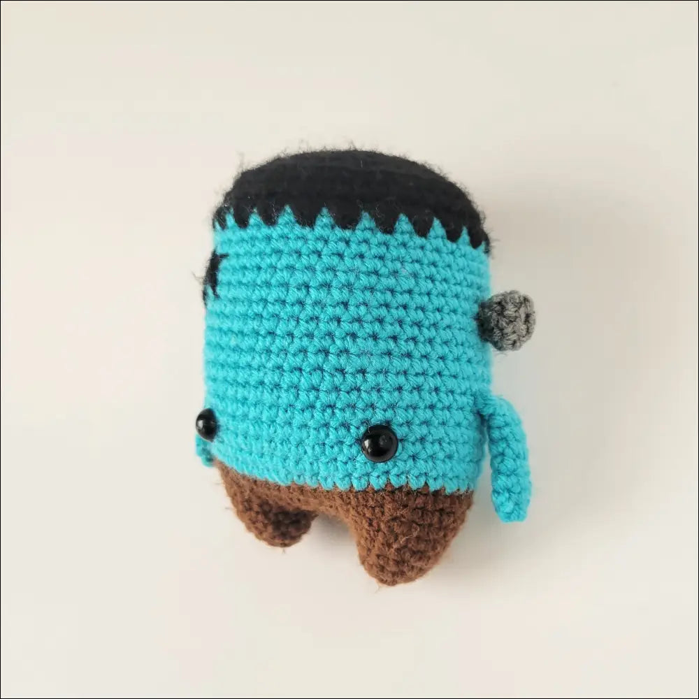 Crocheted turquoise Frankenstein plush toy with brown feet for your monster collection