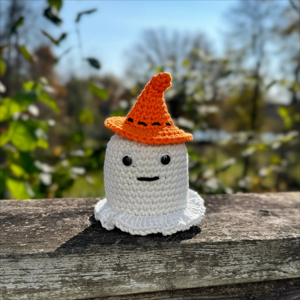 Crocheted glowing ghost figurine with an orange hat, perfect Halloween decor