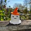 Crocheted glowing ghost figurine with an orange hat, perfect Halloween decor