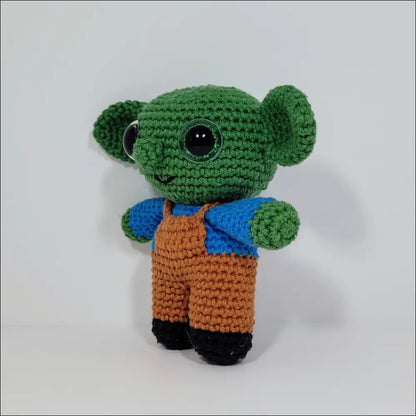 Crochet green alien in blue shirt and brown pants, perfect Goblins Fun Pals at checkout