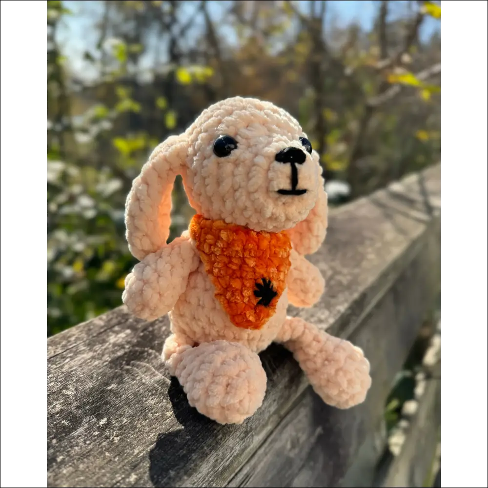 Crocheted Bandana Puppy toy in a vibrant orange vest with a Halloween spider bandana