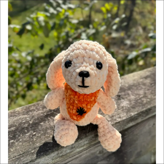 Crocheted stuffed rabbit toy with an orange floral bandana, perfect for a bandana puppy