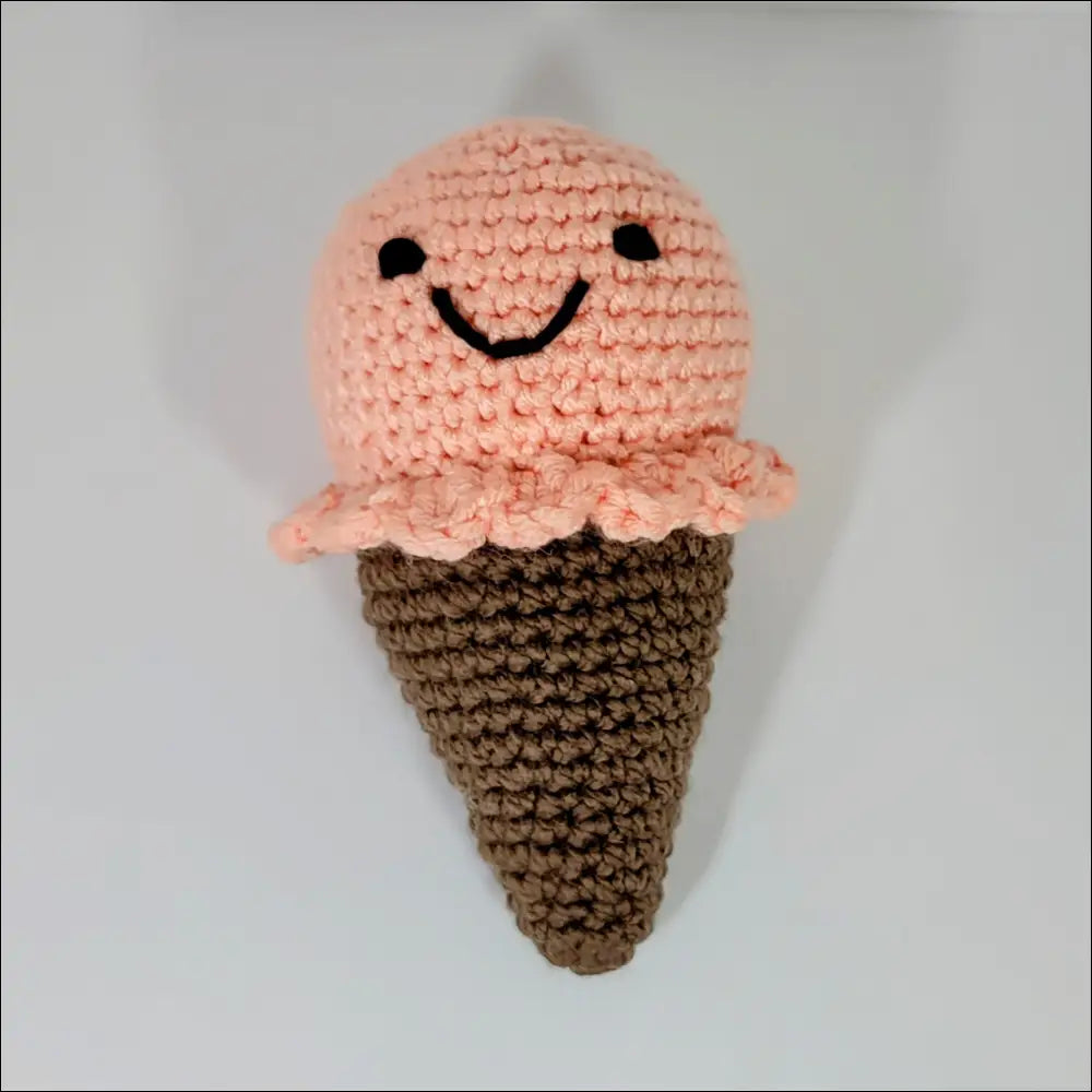 Crocheted pink ice cream plush with a cute smile for your cozy space decor