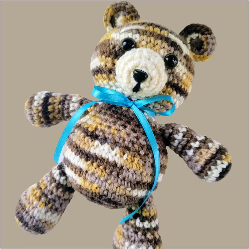 Cuddly Jeremy Bear with striped fur and blue ribbon, the perfect toy for on-the-go fun