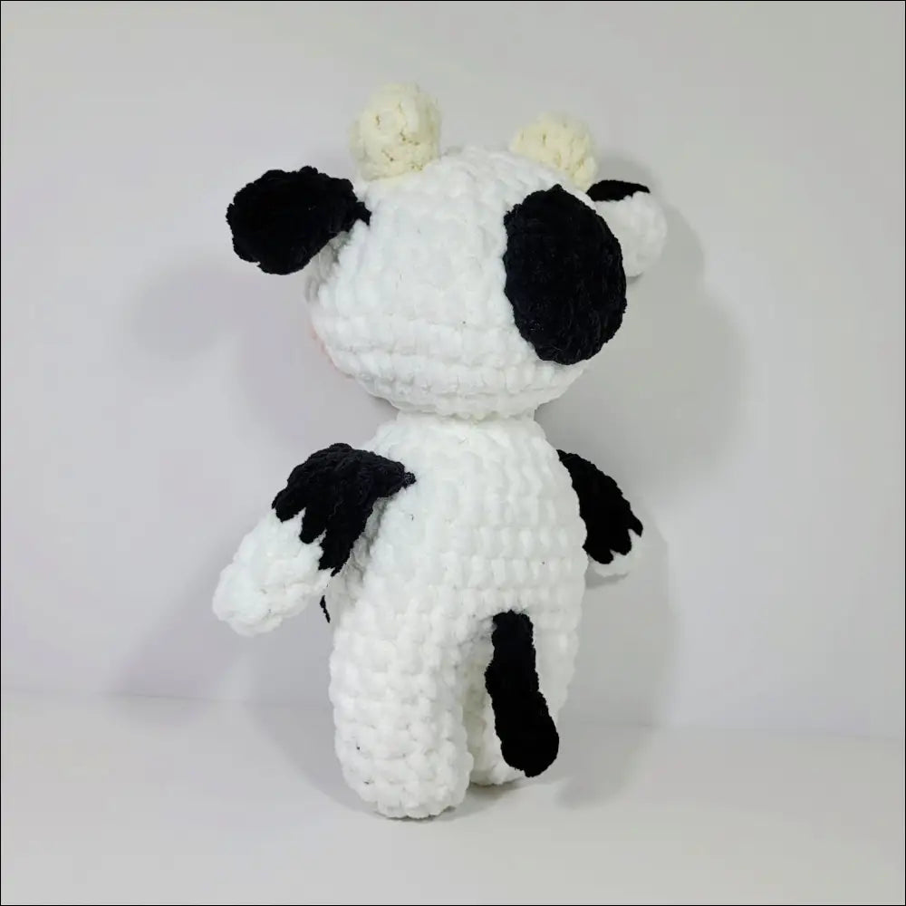 Cozy Jersey Cow Plush toy with black spots, perfect for snuggles and playtime fun