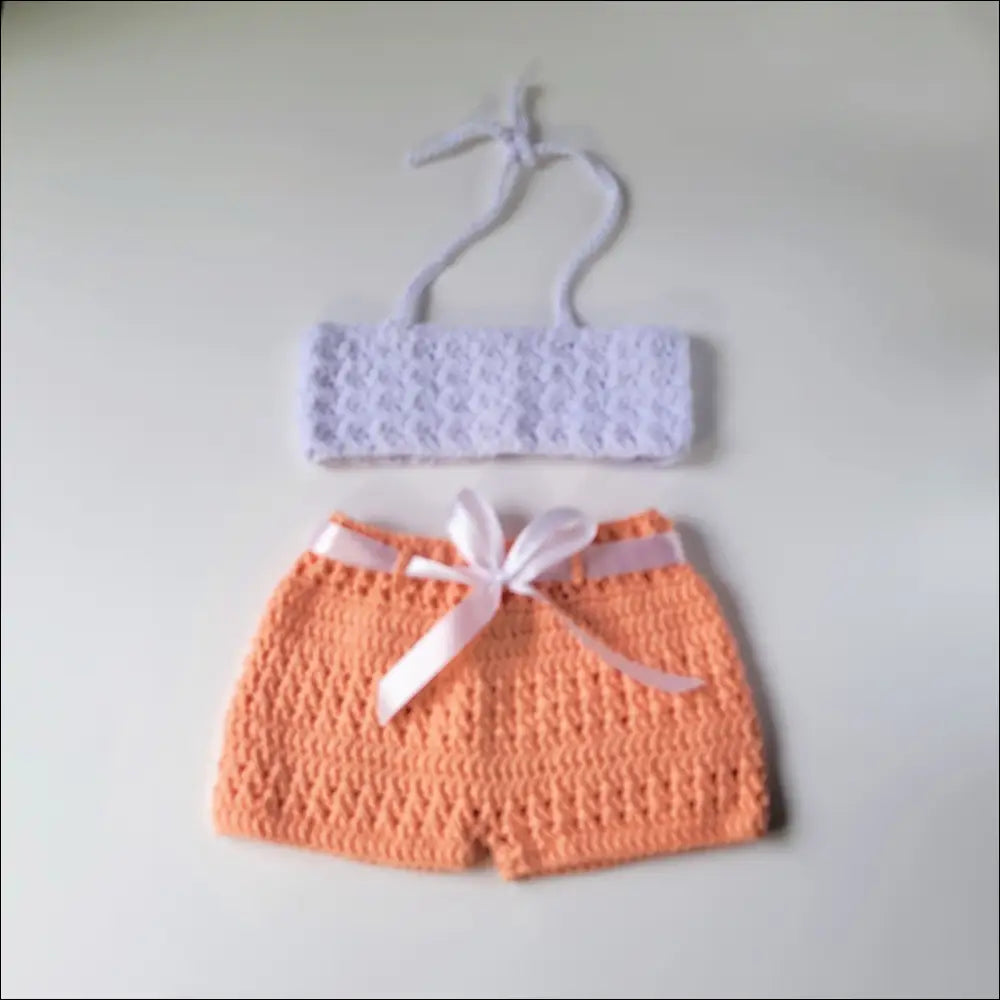 Adorable crocheted baby bikini set featuring a white top and peachy shorts in peachy short set