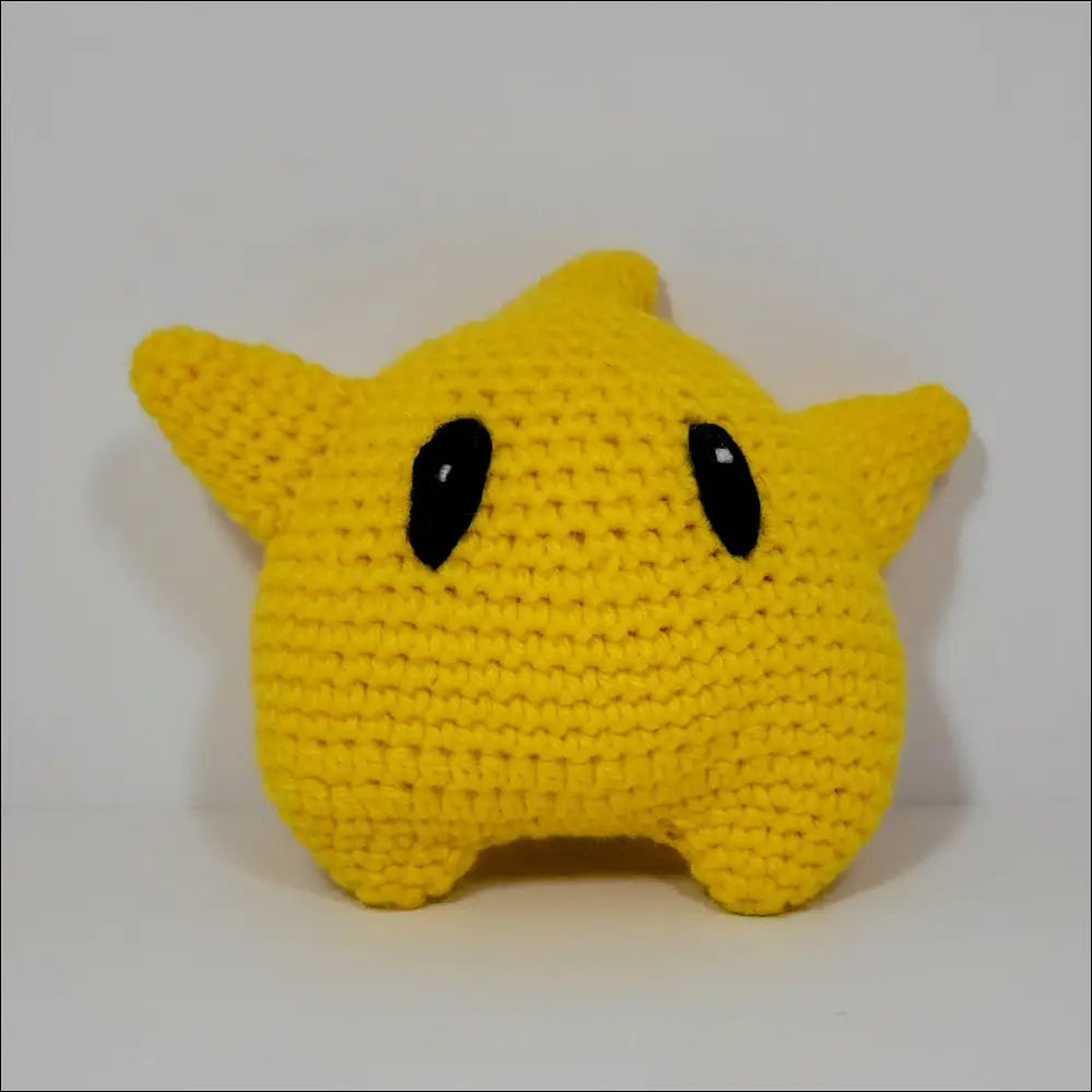 Cute yellow Luma Toy with black eyes and nose for Super Mario fans’ cozy playtime