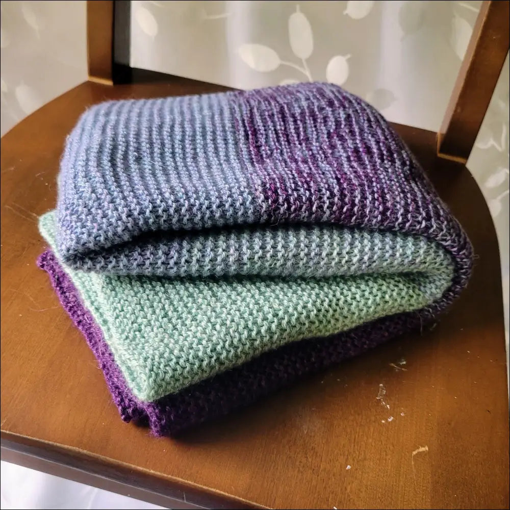 Luxe Gradient Baby Blanket showcasing cozy purple, blue, and green hues in a stylish stack