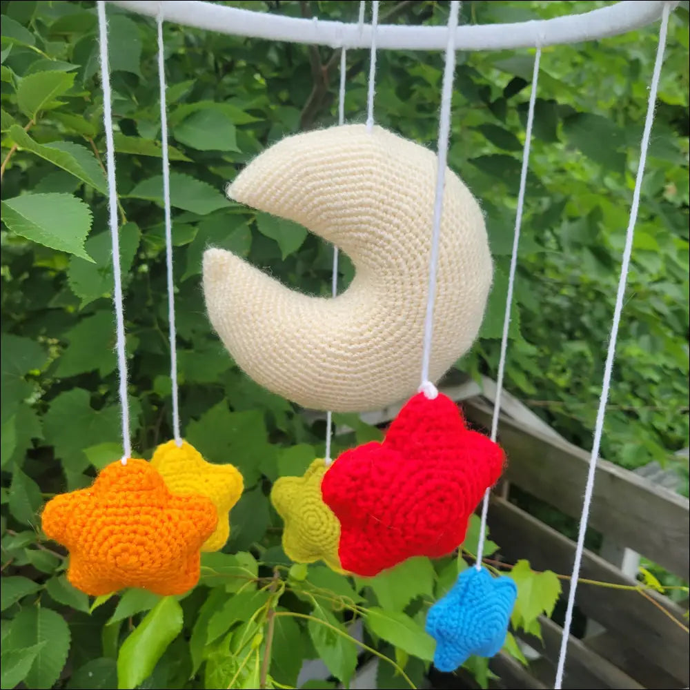 Crocheted Moon & Stars Mobile with cream moon and colorful star shapes for kids’ room