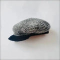 Gray knitted newsboy cap with black brim for kids, adding a vintage touch
