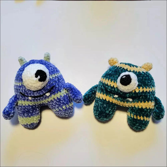 Blue and green one eyed monster toys perfect for Halloween decor and costume parties