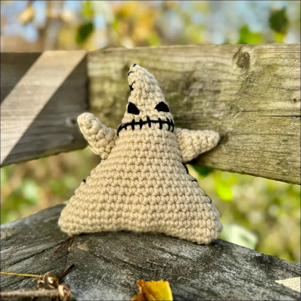 Crocheted beige Oogie Boogie plush ghost toy with a cute smiling face for Halloween fun