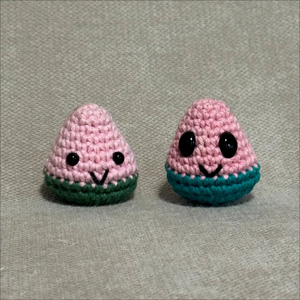 Two small crocheted watermelon slices