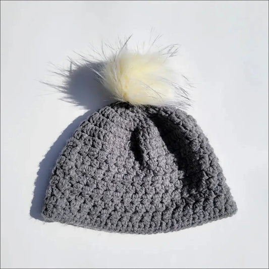 Gray pom-pom beanie hat for toddlers with a fluffy white pom-pom on top