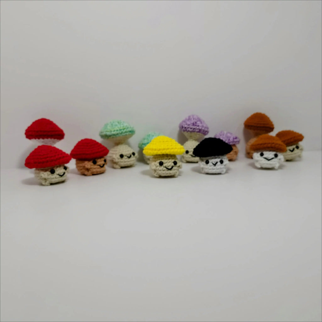Vibrant row of knitted gnomes beside Pop Mushroom Fidget Toy for fun and relaxation