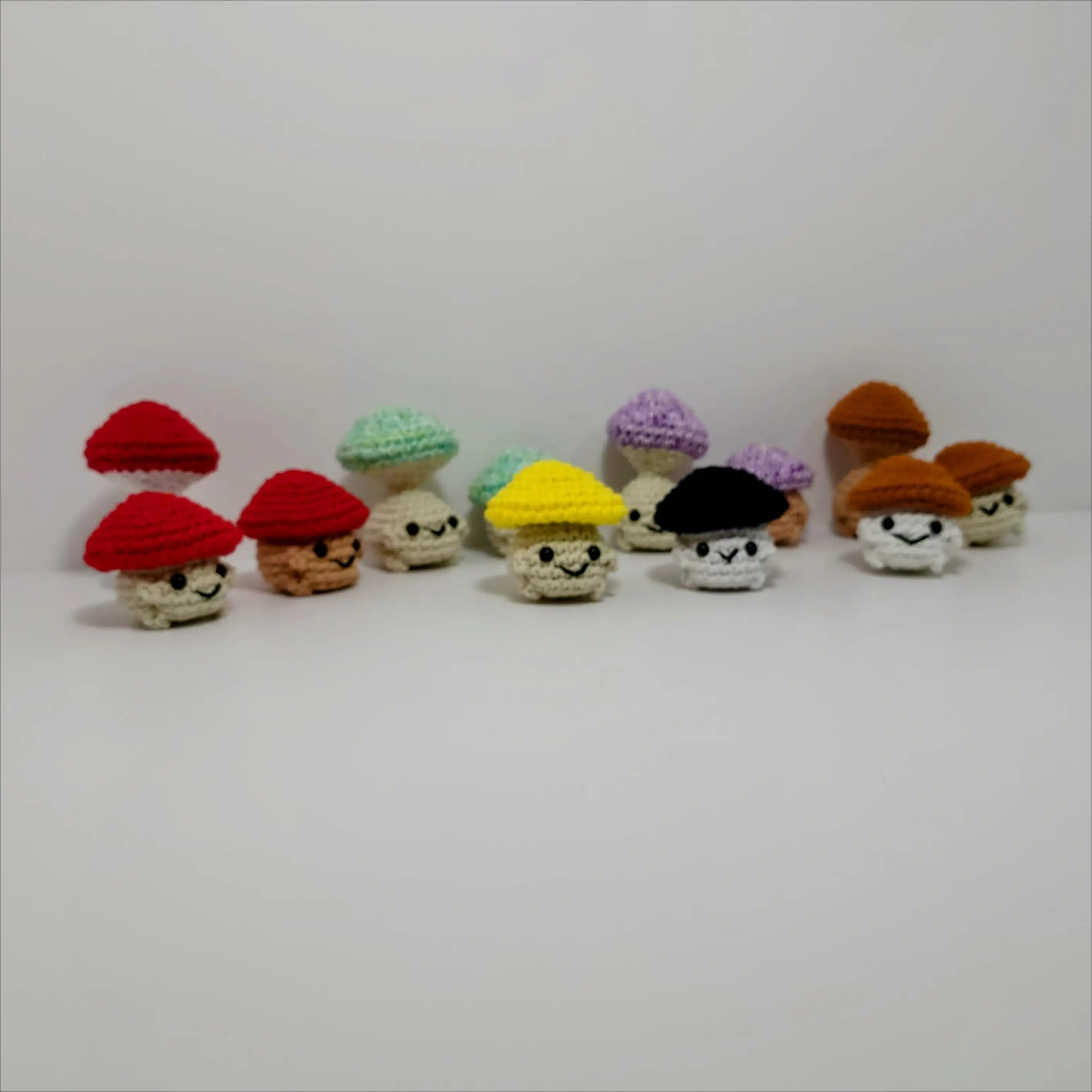 Vibrant row of knitted gnomes beside Pop Mushroom Fidget Toy for fun and relaxation