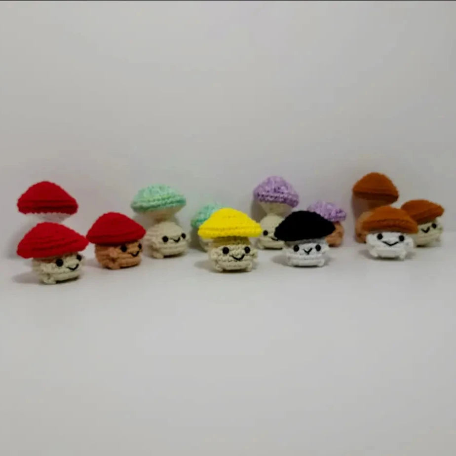 Vibrant row of knitted gnomes beside Pop Mushroom Fidget Toy for fun and relaxation