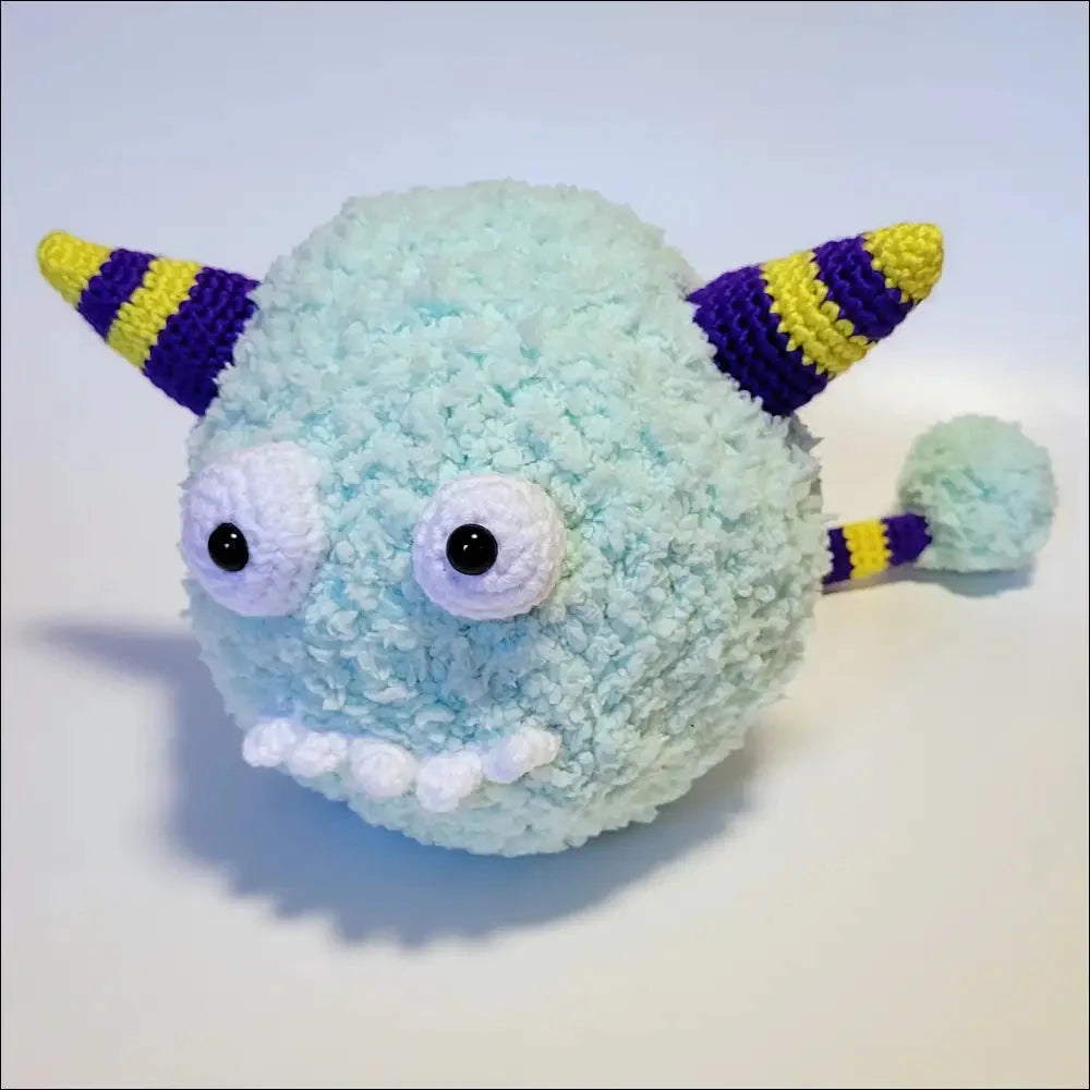 Fluffy light blue Puff Ball Monster plush toy with striped horns and tail for fun