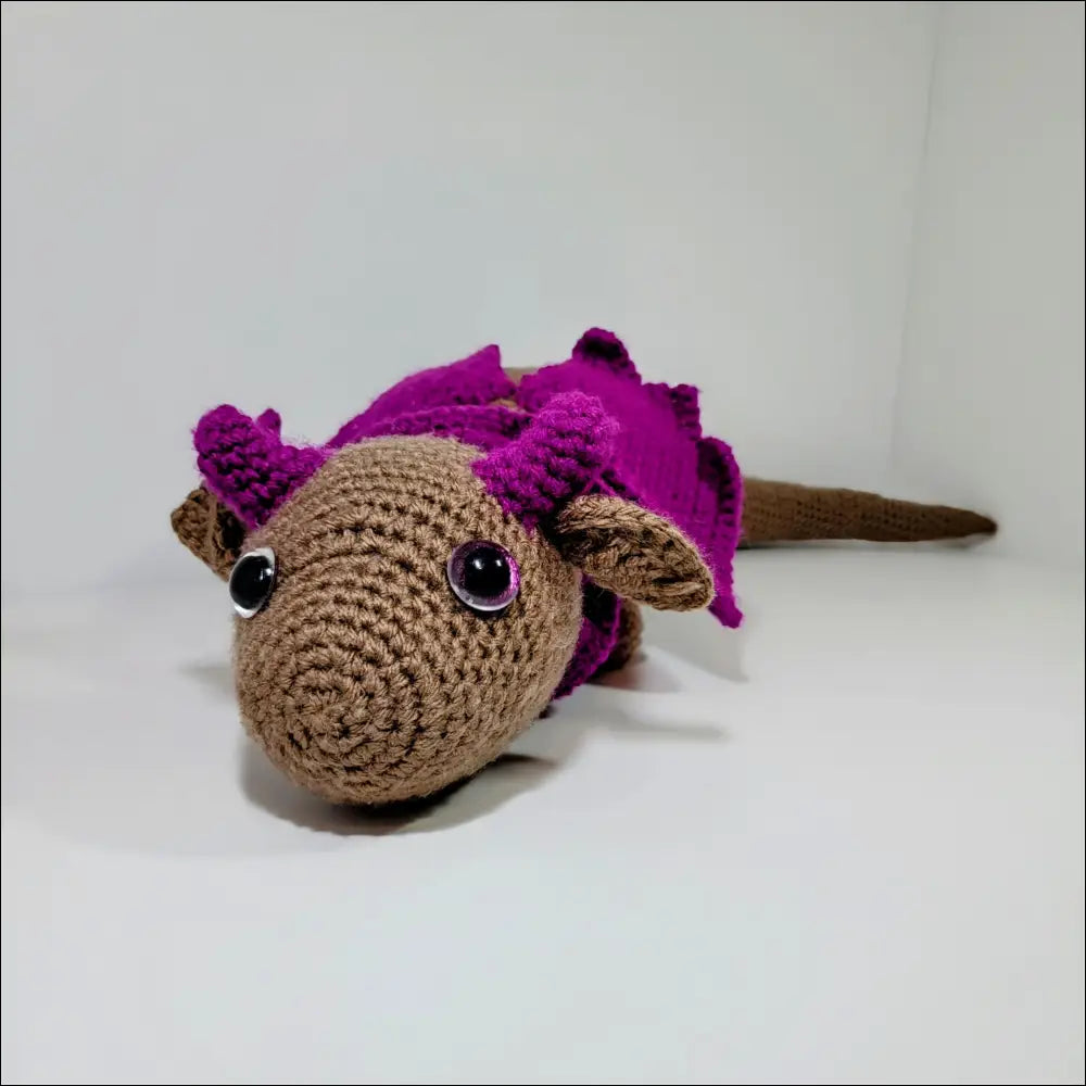 Cute Crocheted Resting Dragon with Tan Body and Purple Spikes for cuddly fun