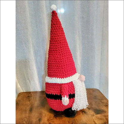 Crocheted red Santa Gnome with a tall hat and white beard for festive holiday decor