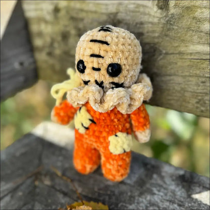 Crocheted Scary Sam doll in an orange jumpsuit for spooky Halloween fun