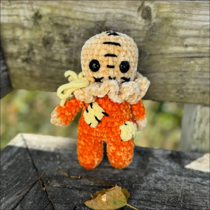 Crocheted Scary Sam doll in orange outfit perfect for spooky Halloween fun