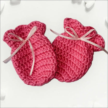 Adorable pink crocheted baby booties with bows, perfect for cozy winter scratch mitts